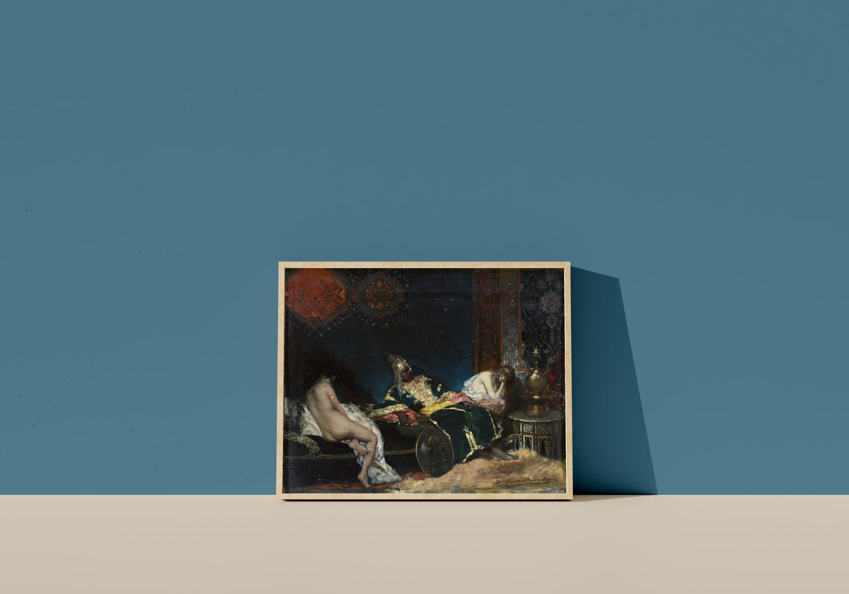 Framed art print of The Serbian Concubine by Jean-Joseph Benjamin-Constant, in a light wood frame leaning on a blue wall