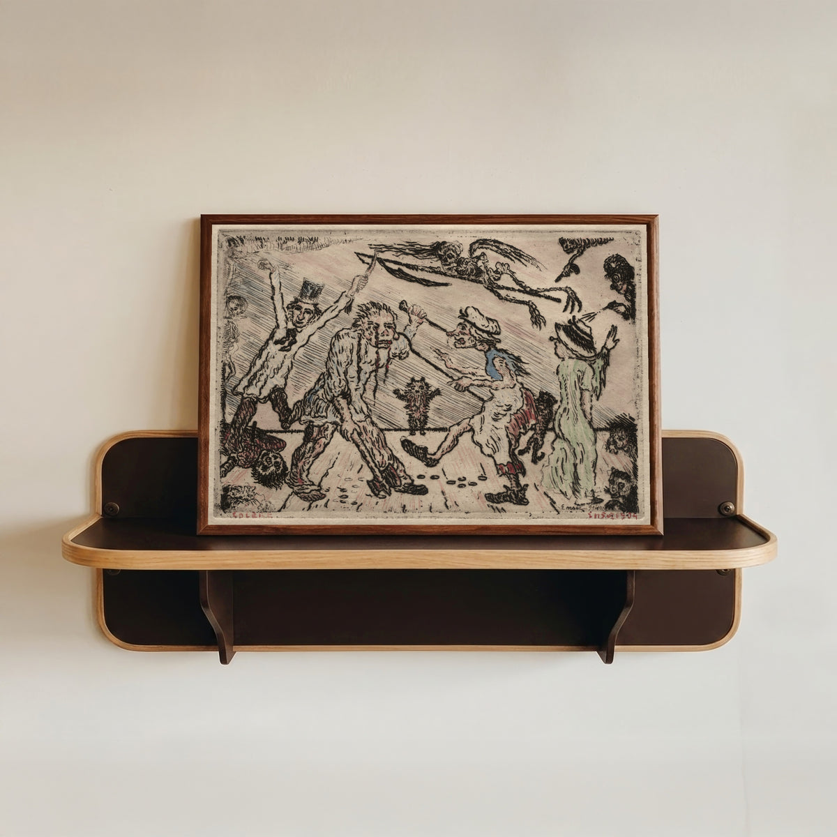 Framed art print of The Seven Deadly Sins: Anger by James Ensor, in a dark wood frame resting on a wall shelf