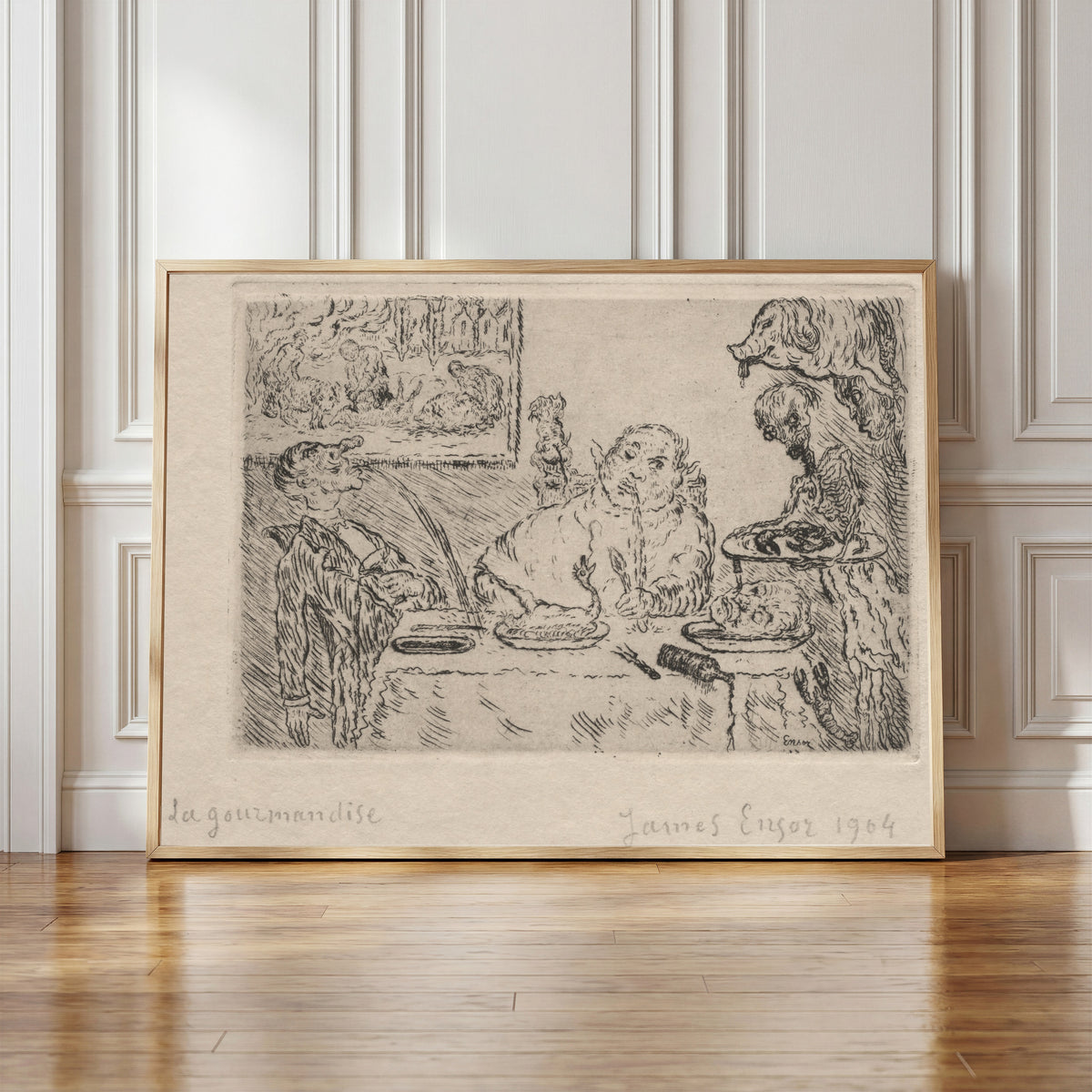 Framed art print of The Seven Deadly Sins: Gluttony by James Ensor, in a light wood frame leaning against a panelled white wall