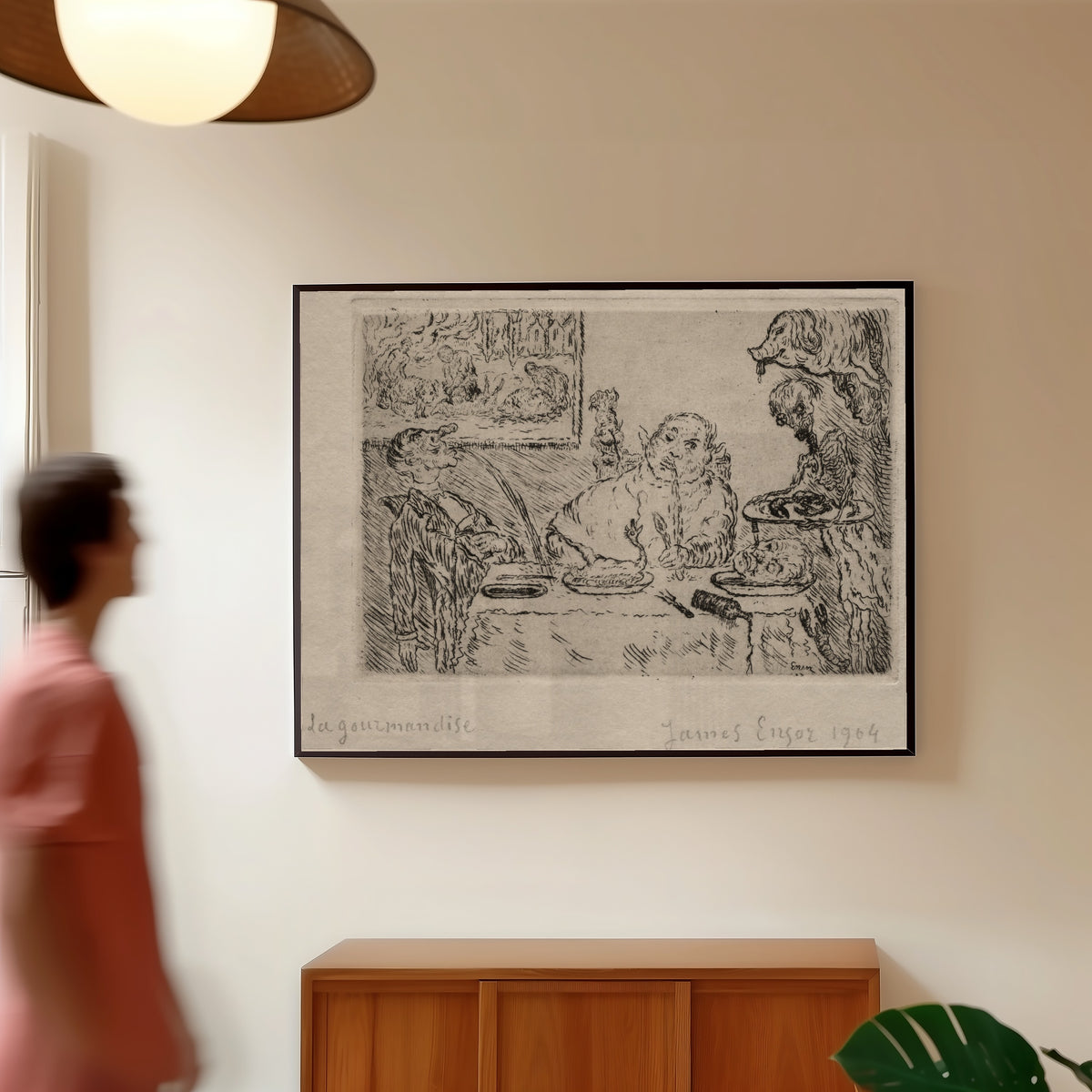 Framed art print of The Seven Deadly Sins: Gluttony by James Ensor, in a slim black frame on a warm wall in a sunlit room