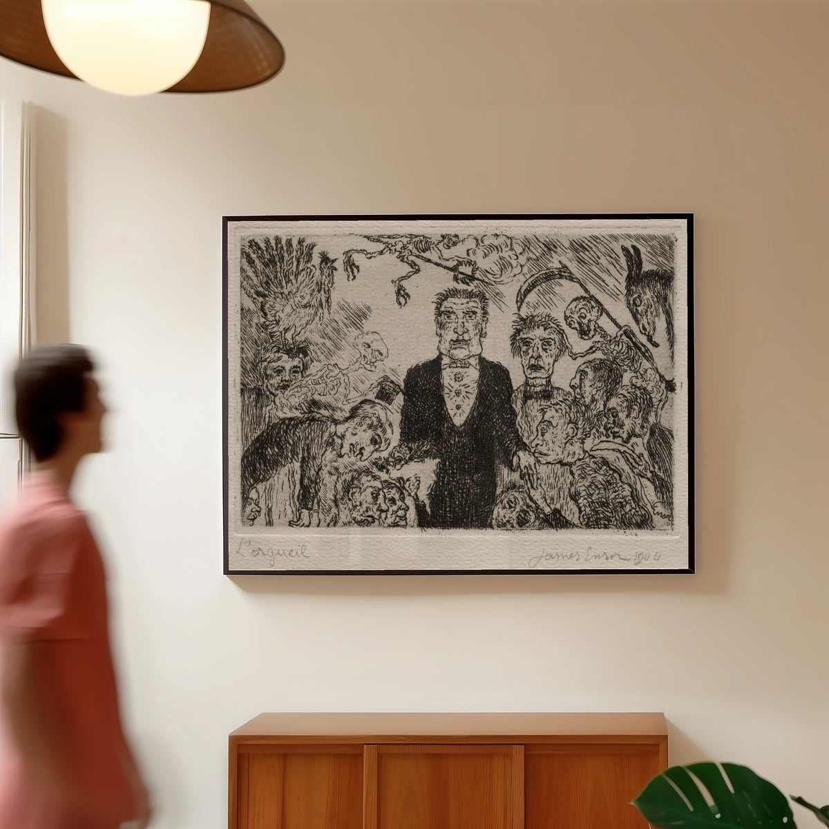 Framed art print of The Seven Deadly Sins: Pride by James Ensor, in a slim black frame on a warm wall in a sunlit room
