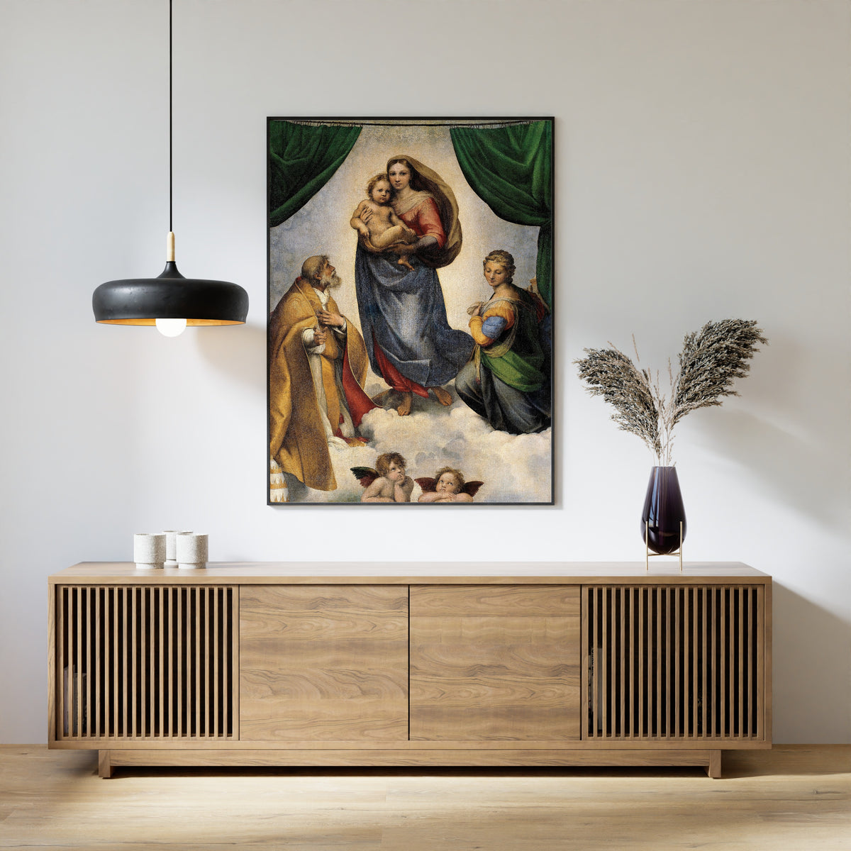 Framed art print of The Sistine Madonna by Raphael, above a slatted wood sideboard