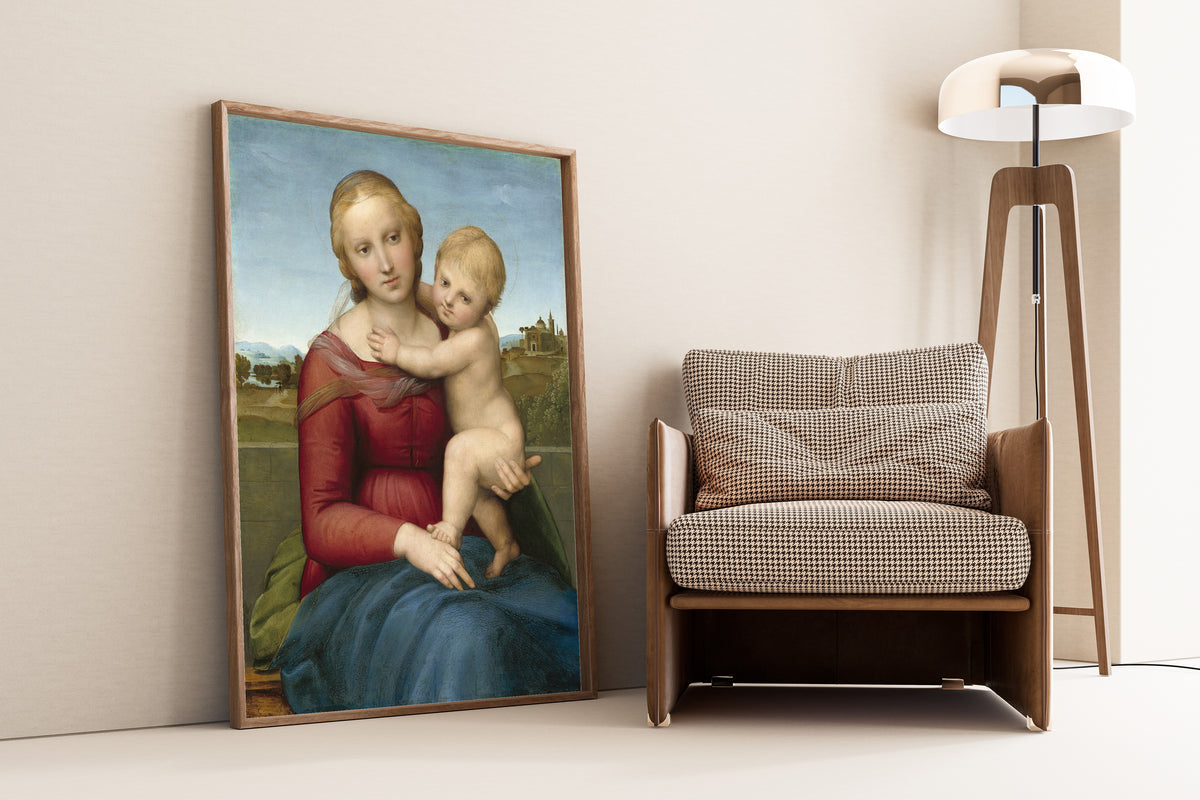 Framed art print of The Small Cowper Madonna by Raphael, leaning against a wall beside an armchair and a floor lamp