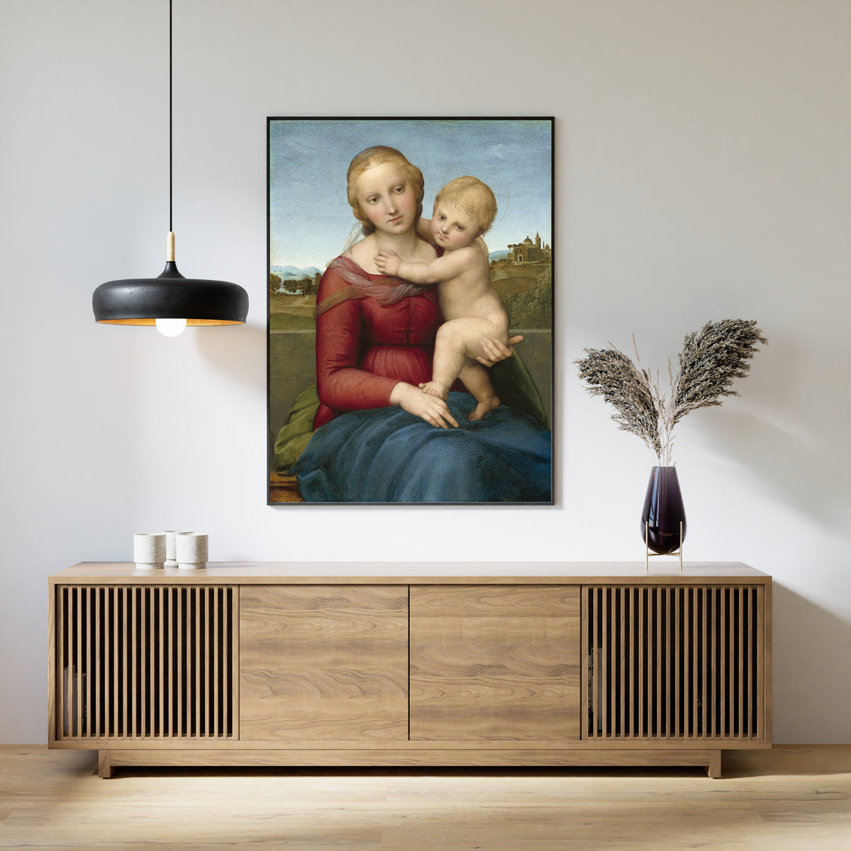 Framed art print of The Small Cowper Madonna by Raphael, above a slatted wood sideboard