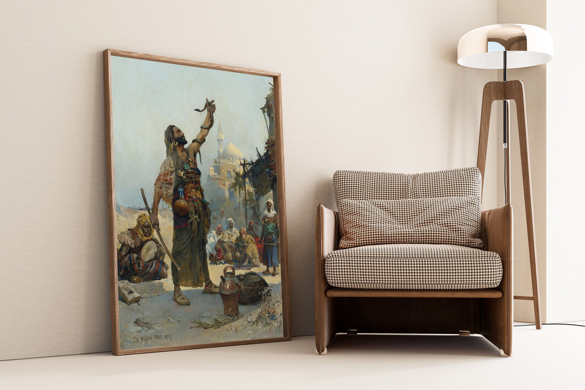 The Snake Charmer by Charles Wilda — framed and leaning against a wall beside an armchair and a floor lamp