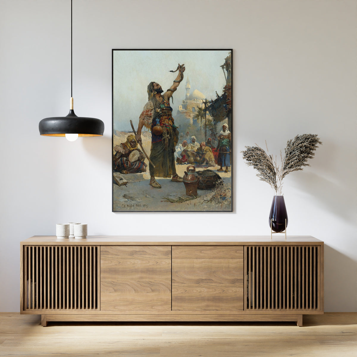 The Snake Charmer by Charles Wilda — framed above a slatted wood sideboard