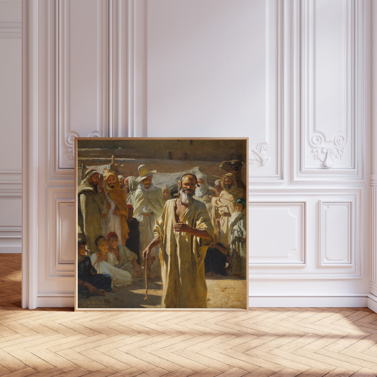 Framed art print of The Snake Charmer by Étienne Dinet, leaning against pale pink panelling on a herringbone floor