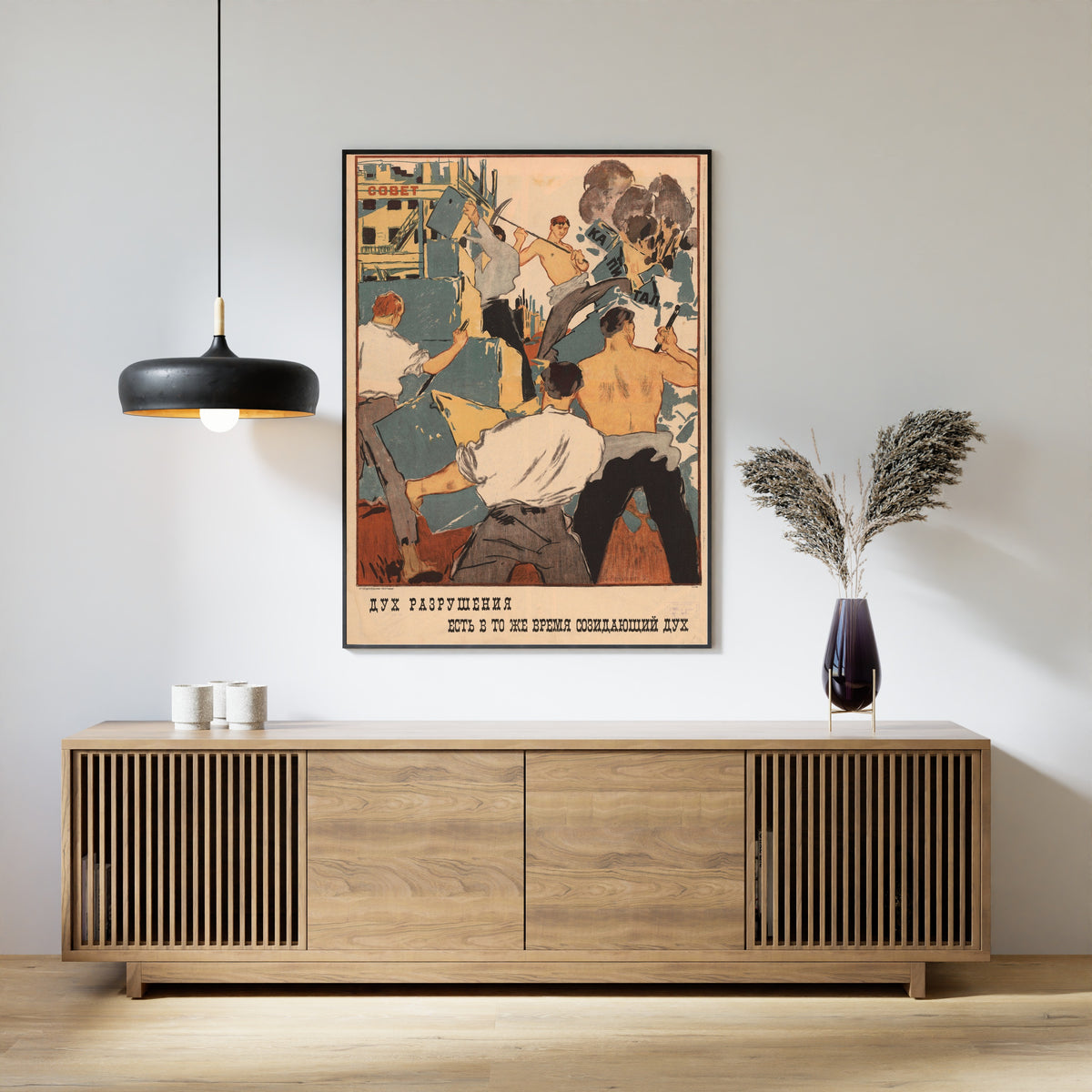 Framed art print of The Spirit of Destruction Is at the Same Time a Creative Spirit, above a slatted wood sideboard