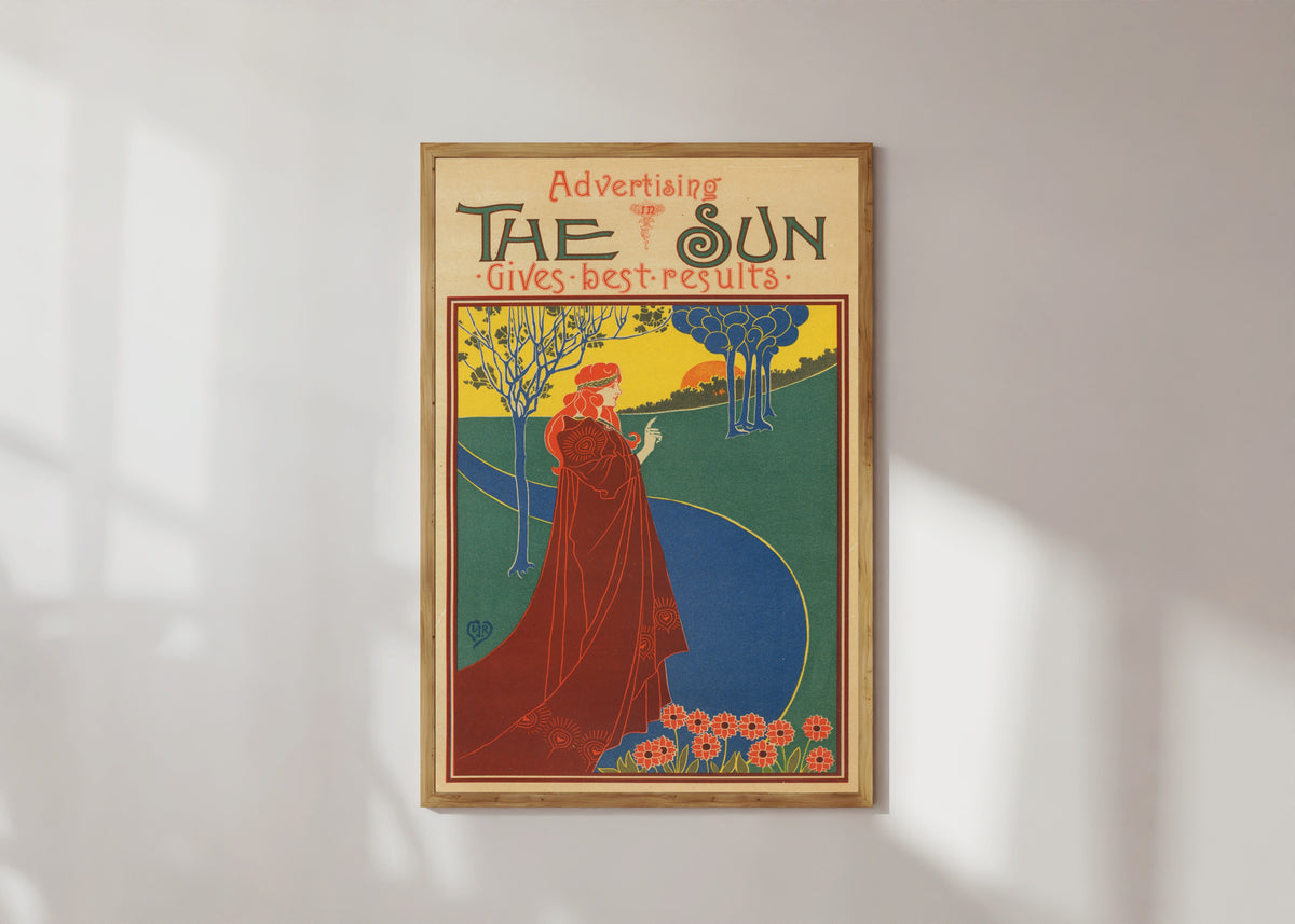 Framed art print of The Sun Gives Good Results by Louis Rhead, in a light wood frame on a sunlit white wall