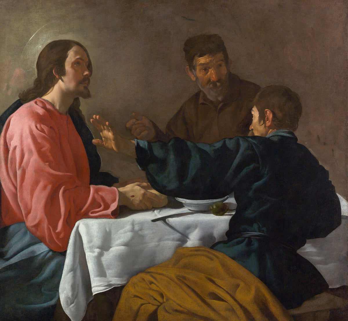 The Supper at Emmaus by Diego Velázquez — Three men at a white-clothed table, one stretching out an open hand