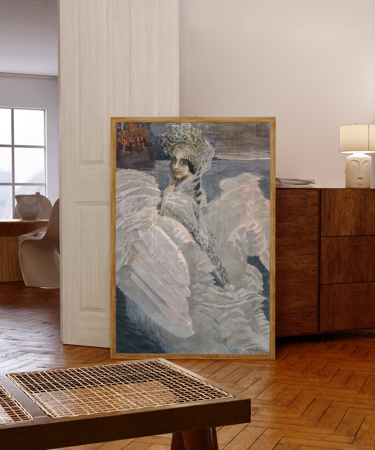 Framed art print of The Swan Princess by Mikhail Vrubel, in a light wood frame leaning in a warm room with a parquet floor