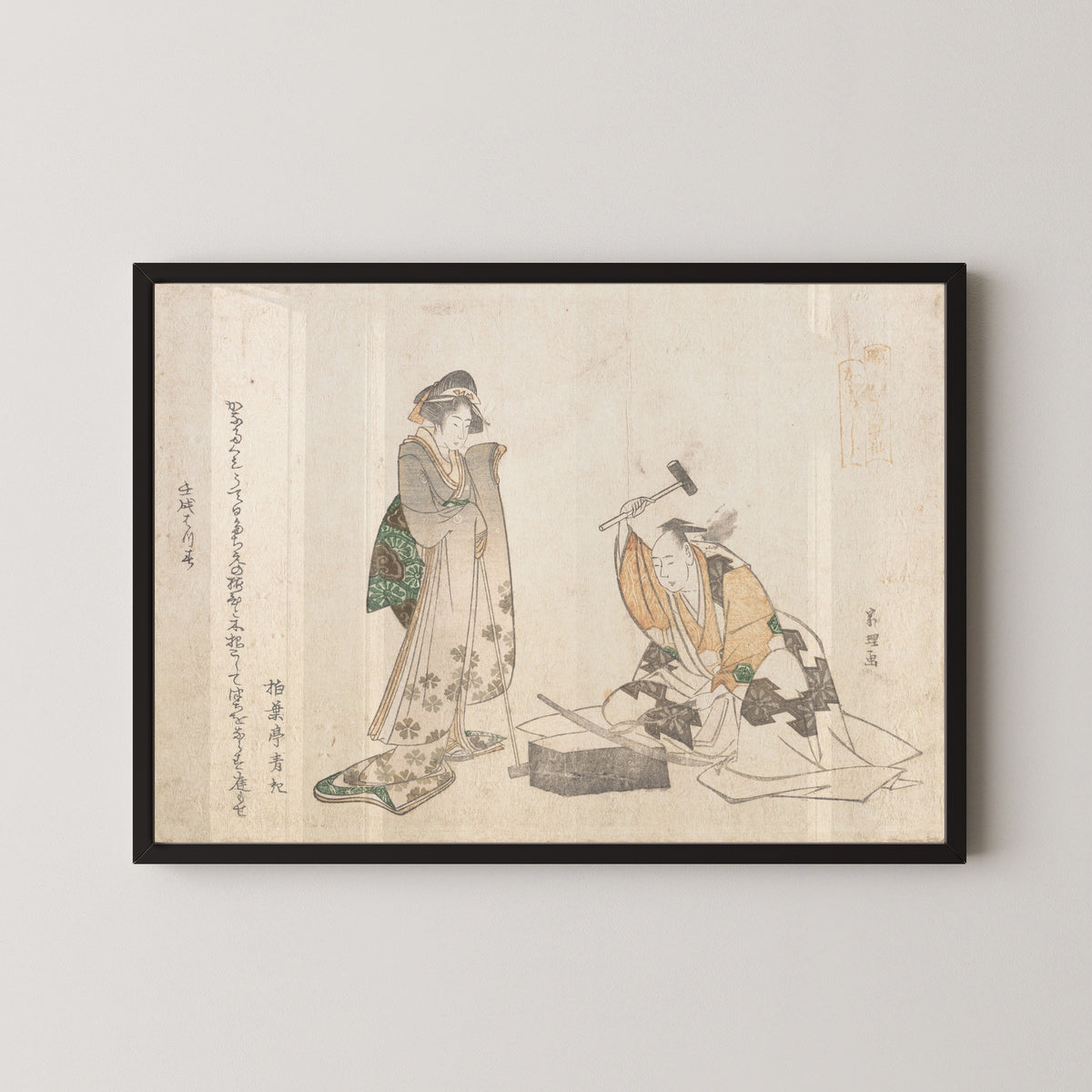 Framed art print of The Swordsmith by Katsushika Hokusai, in a black frame on a pale wall