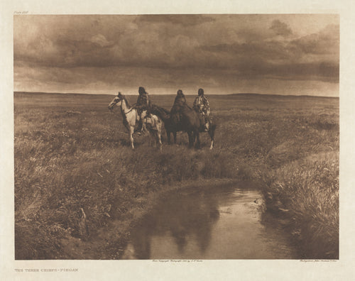 The Three Chiefs, Piegan by Edward S. Curtis — Three Piegan riders pause on the open prairie beneath a heavy sky