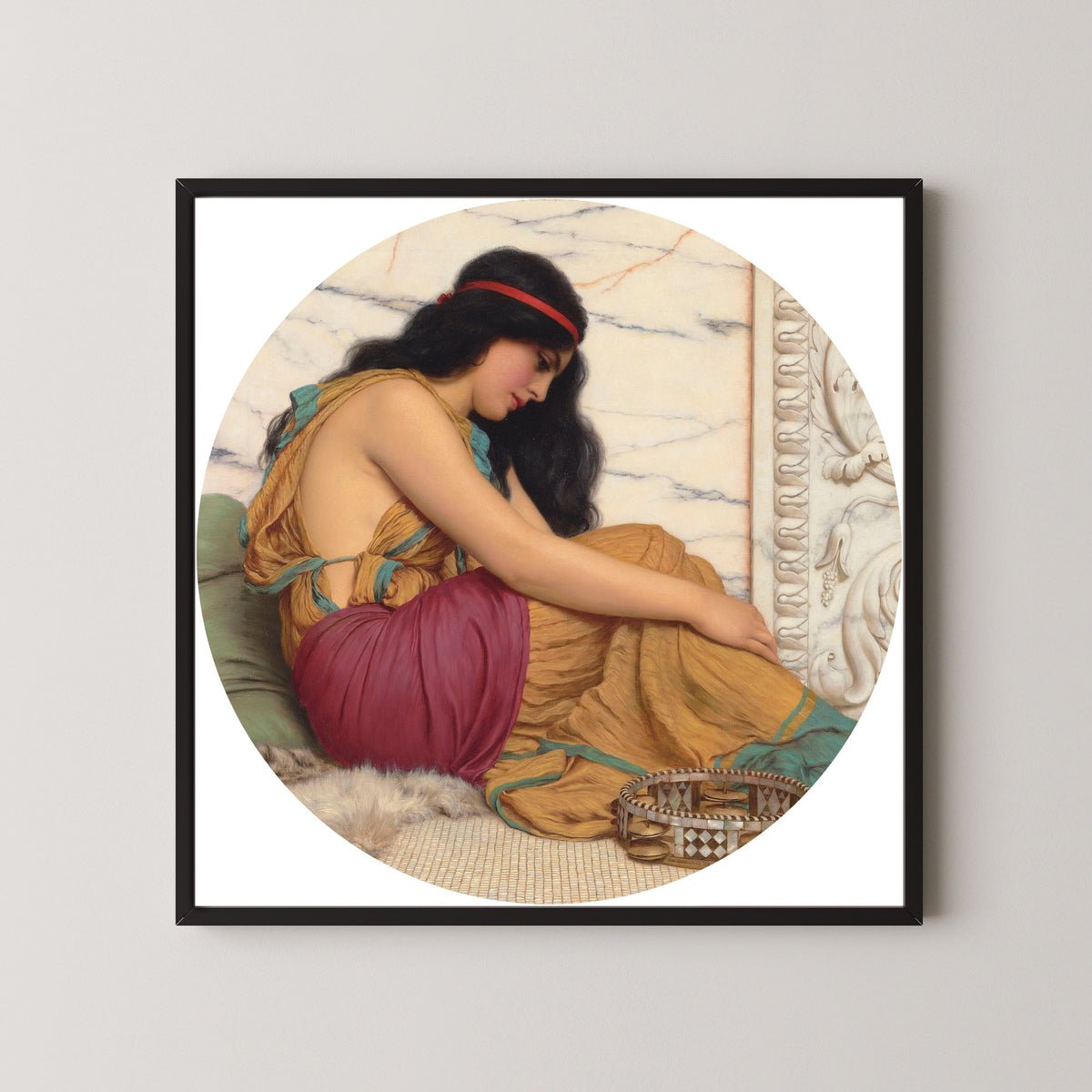 Framed art print of The Tired Danseuse by John William Godward, in a black frame on a pale wall