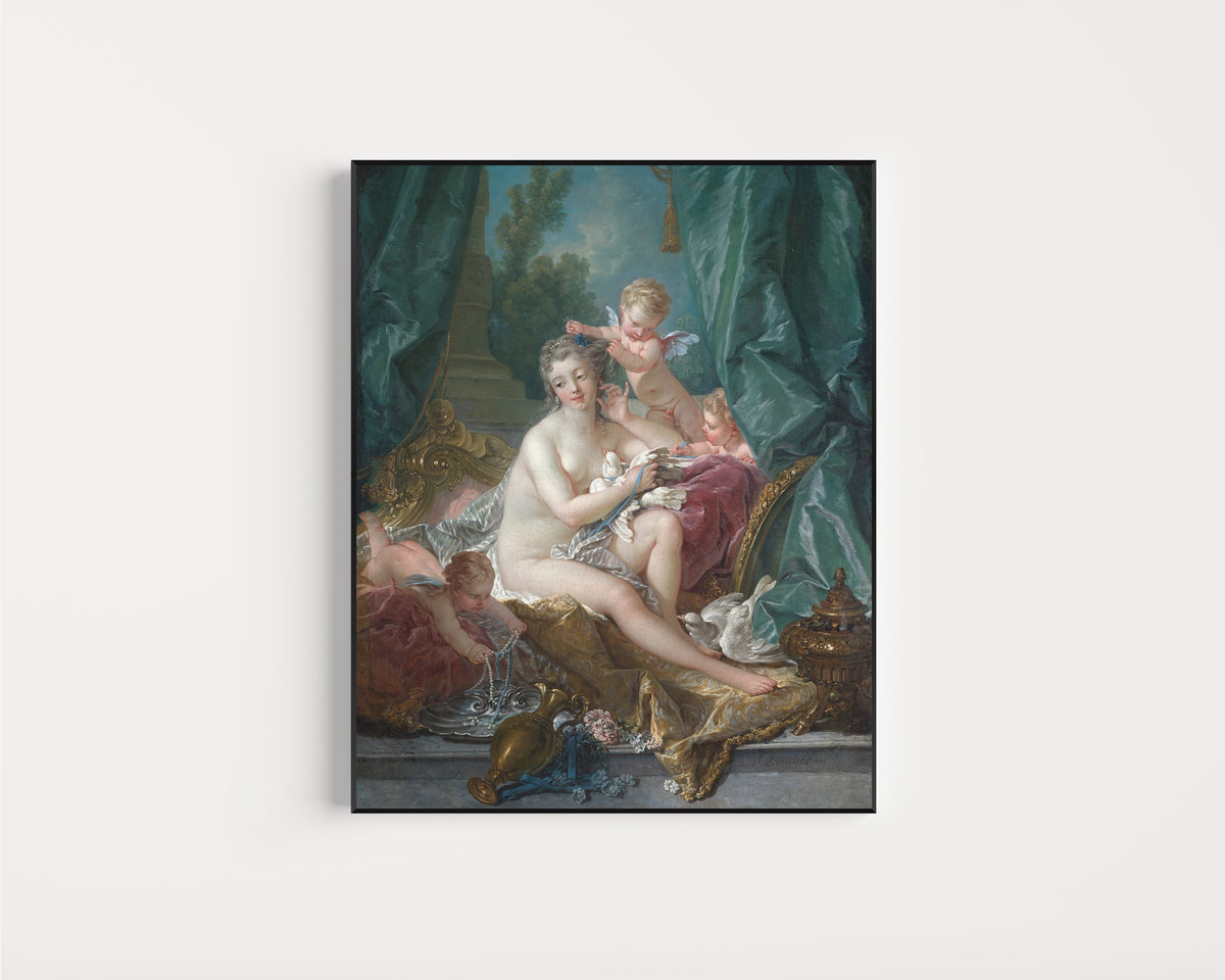 Framed art print of The Toilette of Venus by François Boucher, in a slim black frame on a plain white wall
