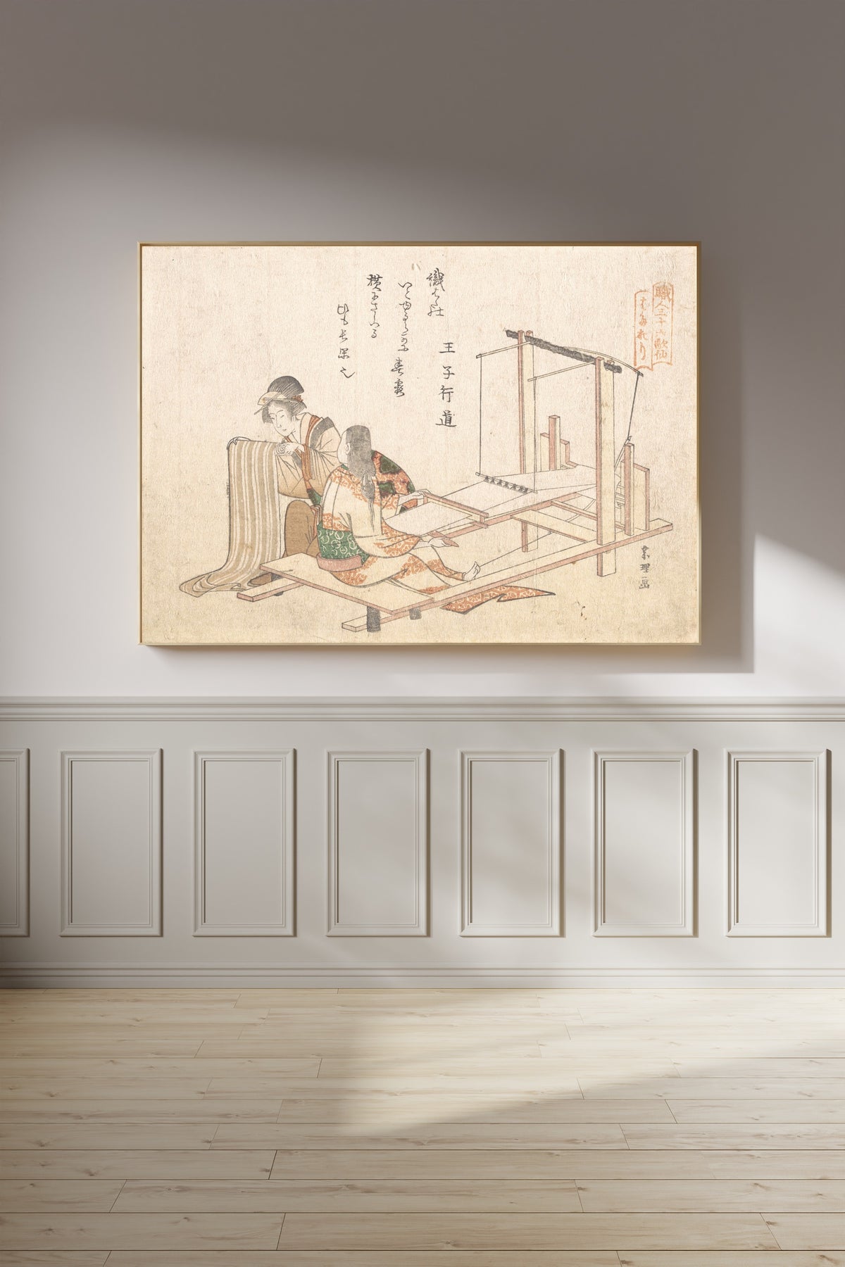 Framed art print of The Weaving Factory by Katsushika Hokusai, on a panelled wall in afternoon light