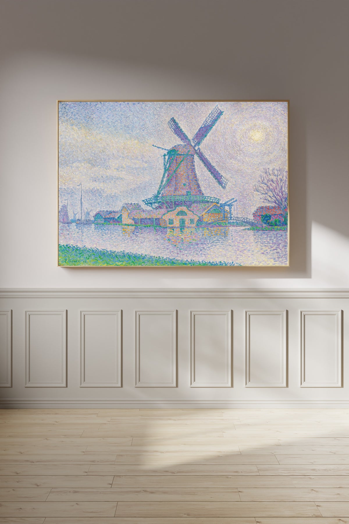 Framed art print of The Windmill at Edam by Paul Signac, on a panelled wall in afternoon light