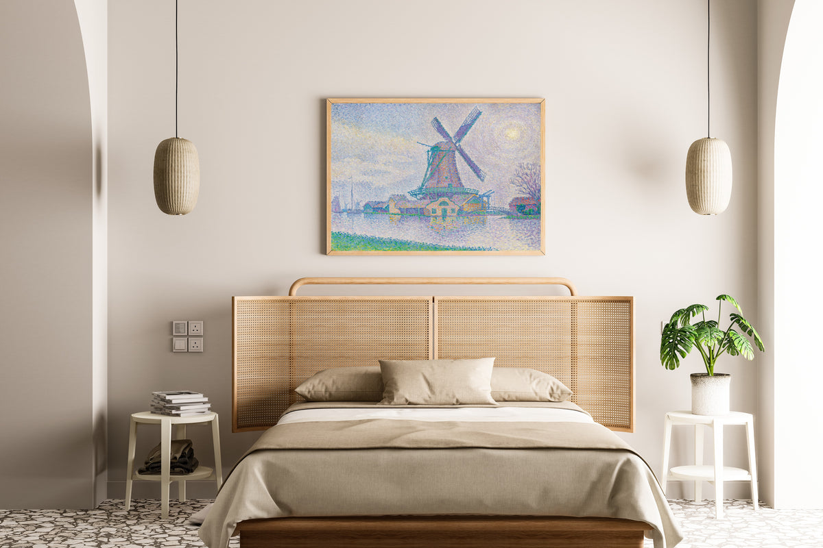 Framed art print of The Windmill at Edam by Paul Signac, above a cane-headboard bed