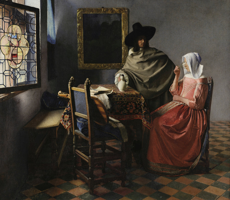 Johannes Vermeer — The Wine Glass | Fine Art Print shown to scale on a wall above a sofa