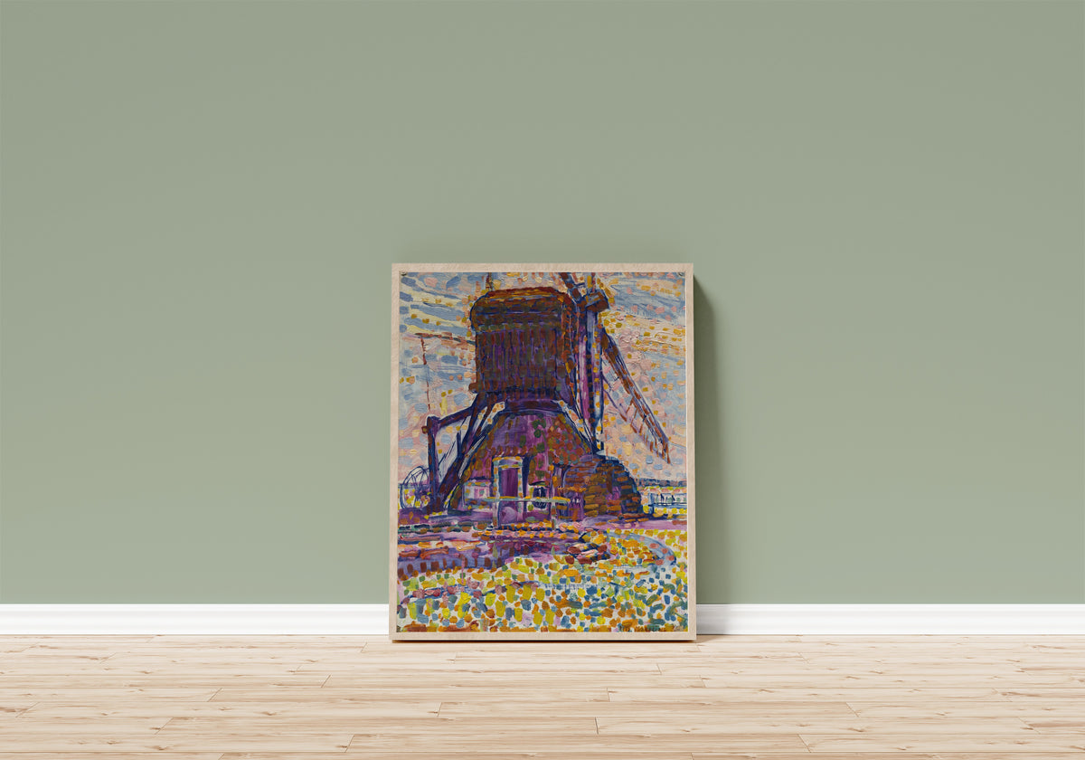 Framed art print of The Winkel Mill by Piet Mondrian, in a light wood frame leaning on a sage green wall above a wooden floor