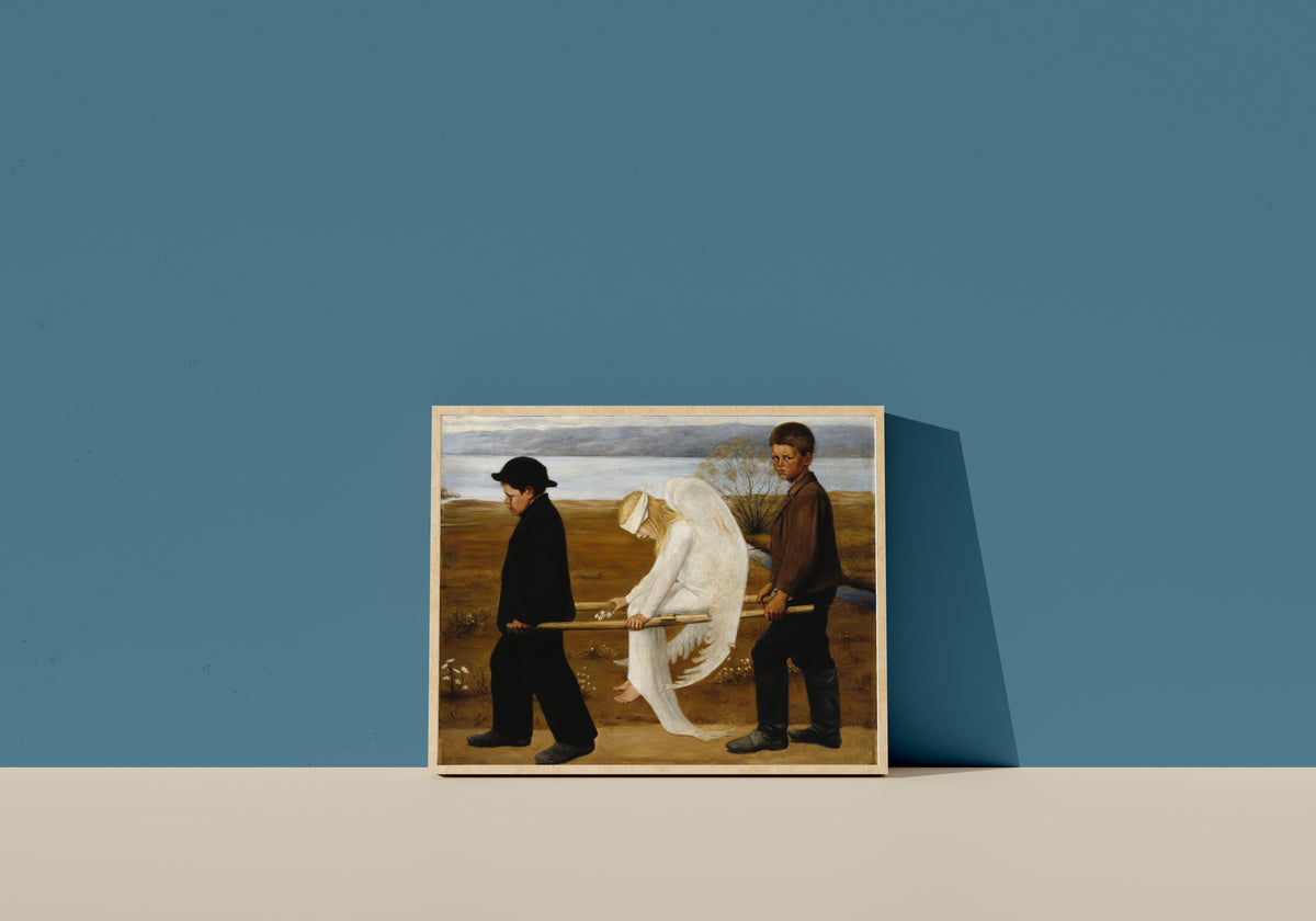 Framed art print of The Wounded Angel by Hugo Simberg, in a light wood frame leaning on a blue wall