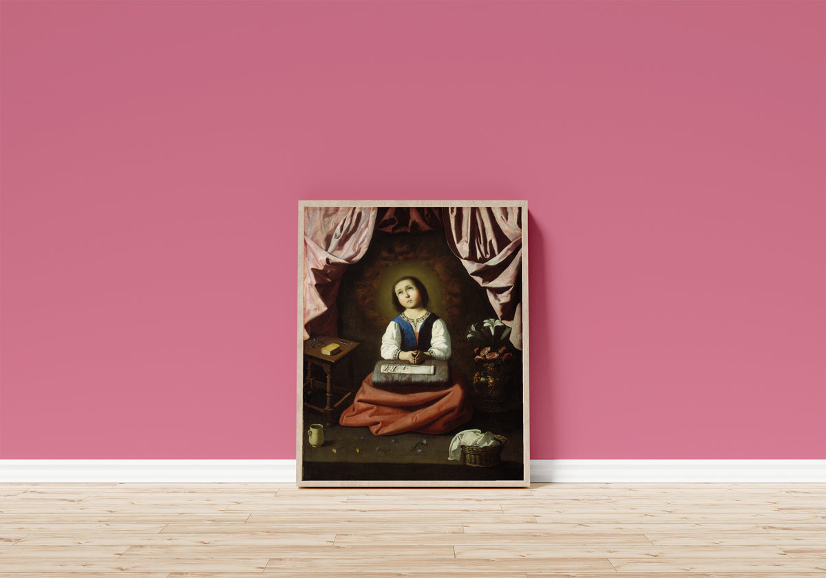 Framed art print of The Young Virgin by Francisco de Zurbarán, in a light wood frame leaning on a pink wall above a wooden floor