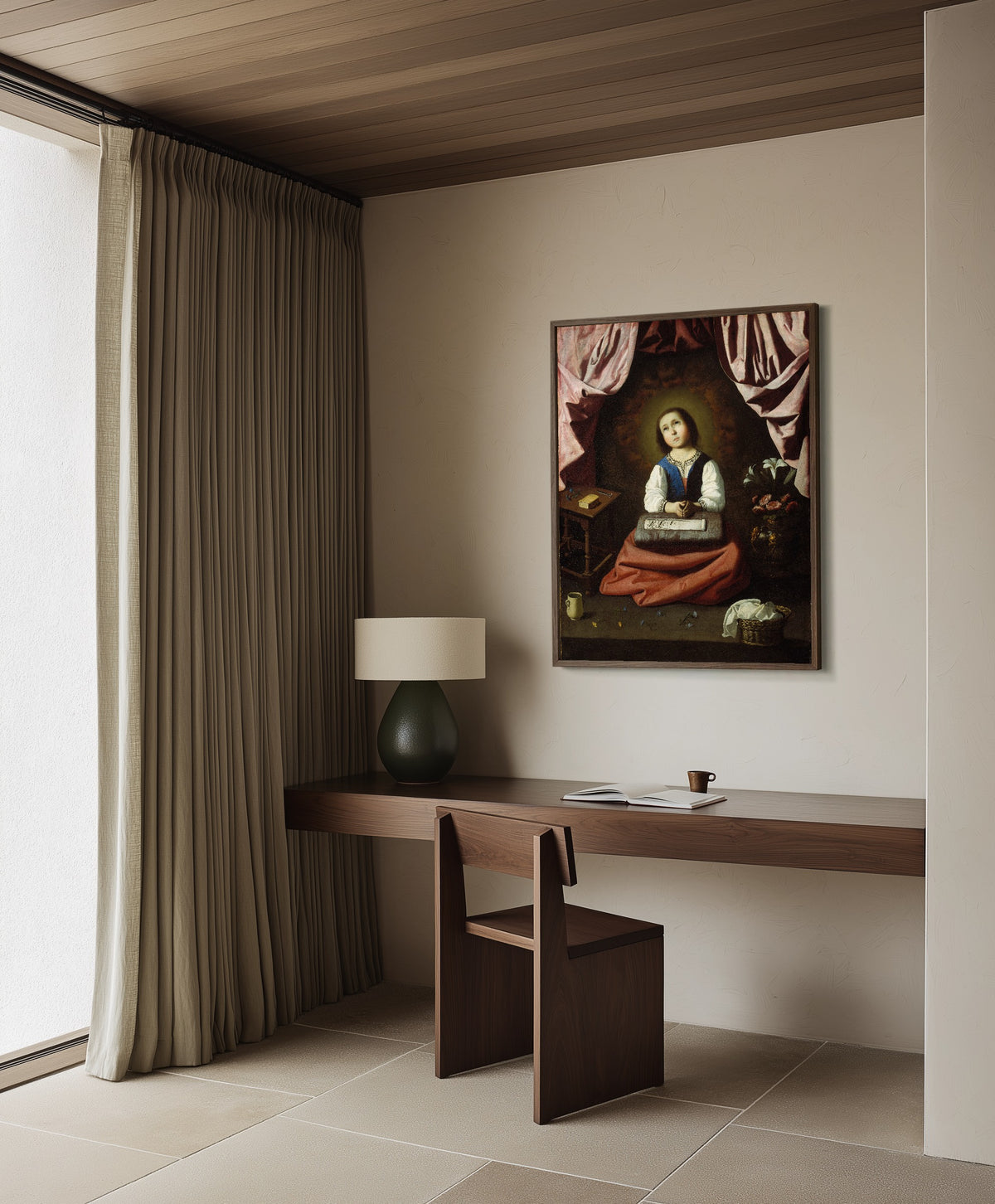 Framed art print of The Young Virgin by Francisco de Zurbarán, in a dark wood frame on a plaster wall above a walnut desk