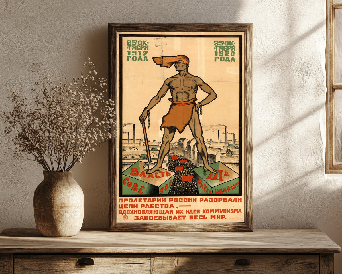 Framed art print of The proletarians of Russia have broken the chains… by Sergey Ivanov, in a dark wood frame leaning on a rustic console beside dried flowers