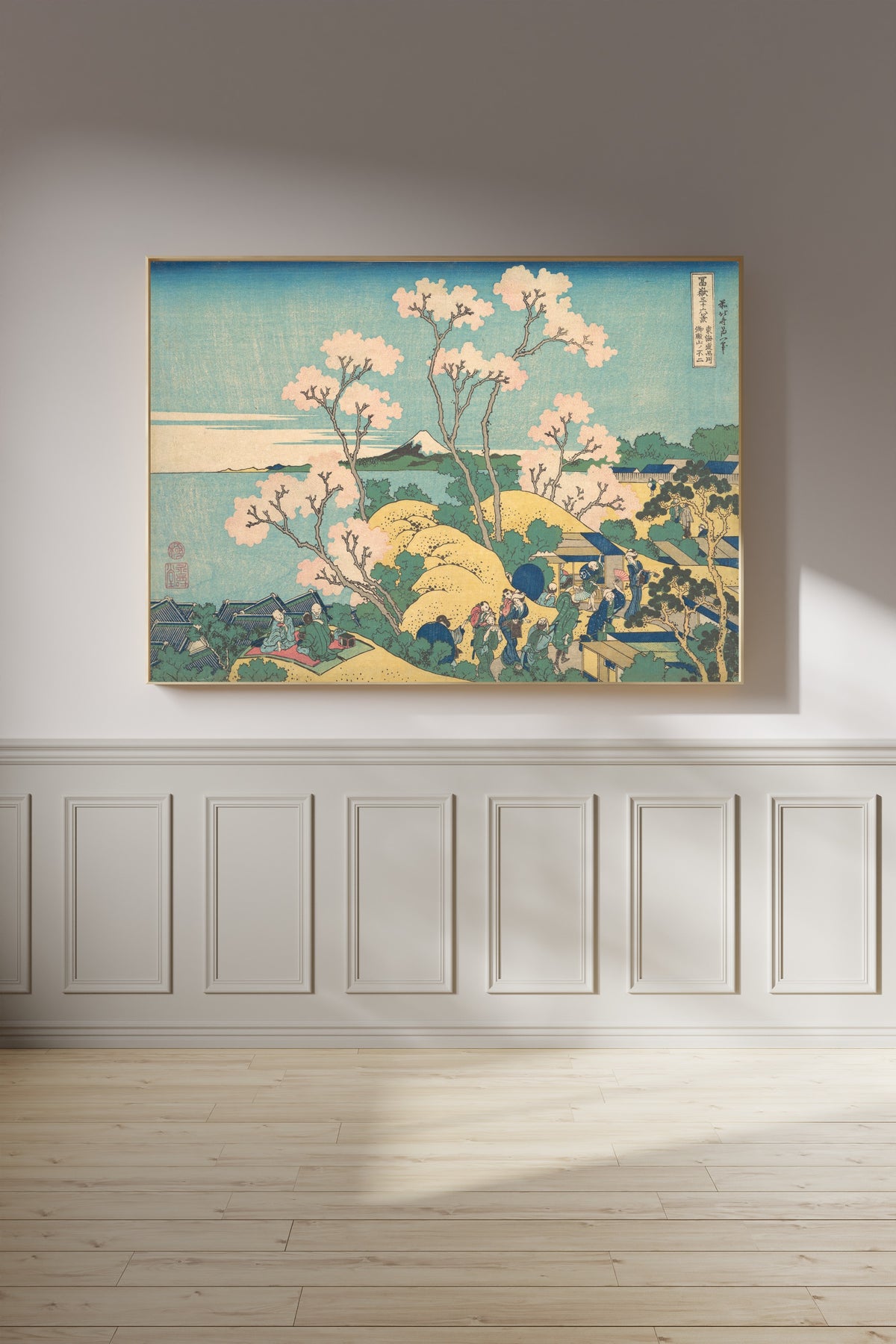 Framed art print of Thirty-six Views of Mount Fuji: Fuji from Gotenyama on the Tōkaidō at Shinagawa by Katsushika Hokusai, on a panelled wall in afternoon light