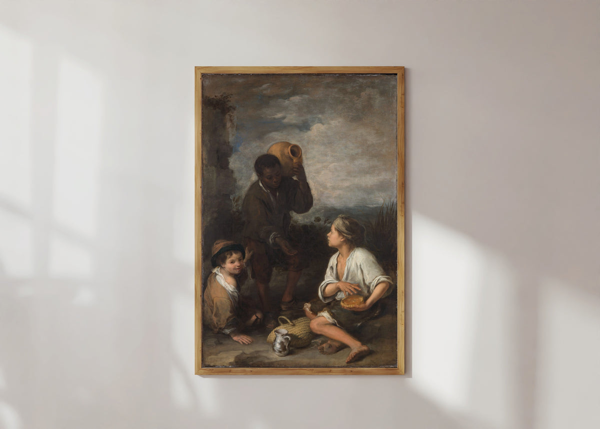 Framed art print of Three Boys by Bartolomé Esteban Murillo, in a light wood frame on a sunlit white wall