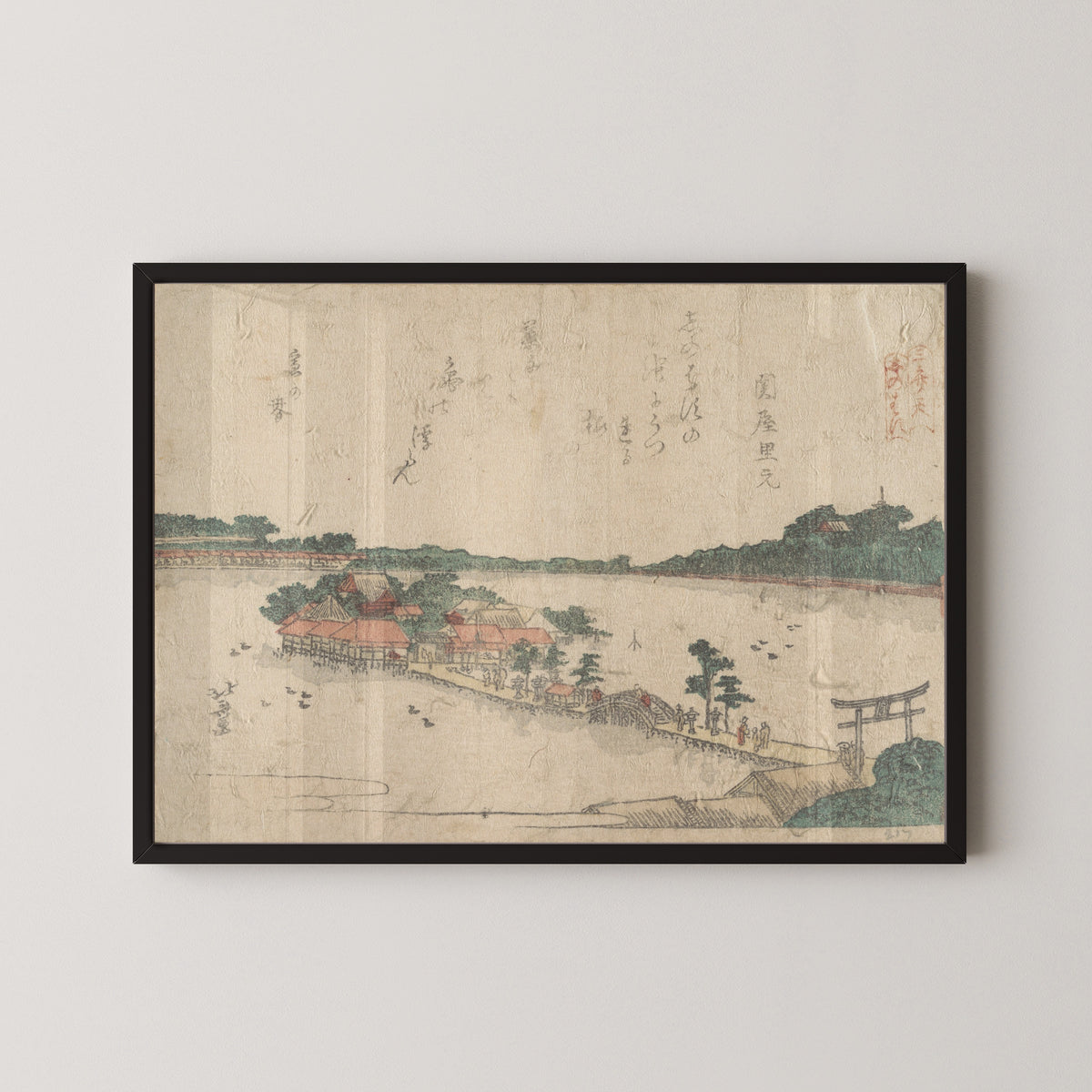 Framed art print of Three Shrines of the Goddess Benten: Shinobazu Pond in Ueno by Katsushika Hokusai, in a black frame on a pale wall