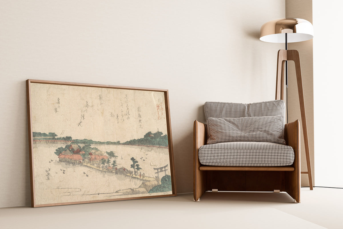 Framed art print of Three Shrines of the Goddess Benten: Shinobazu Pond in… by Katsushika Hokusai, leaning against a wall beside an armchair and a floor lamp