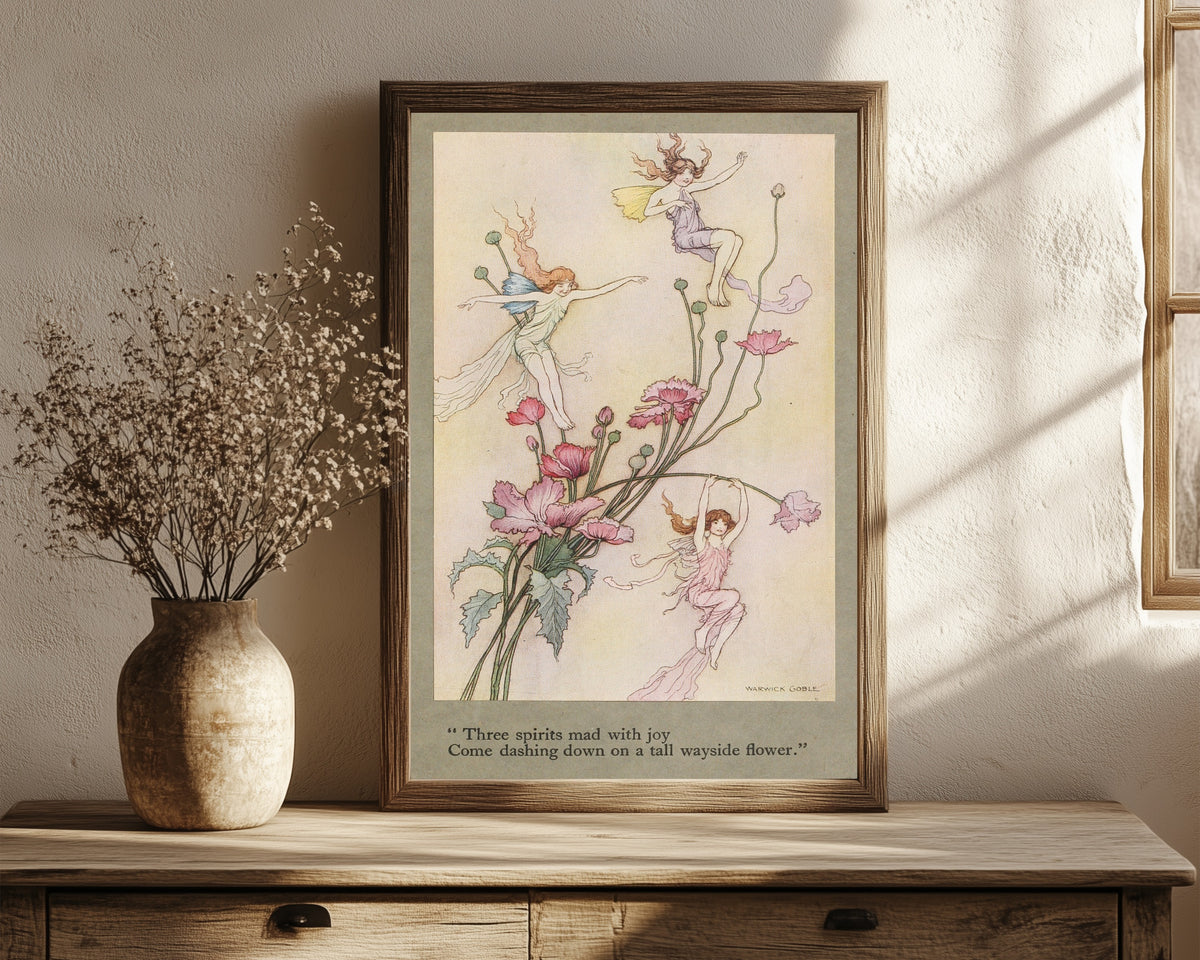 Framed art print of Three spirits mad with joy come dashing down on a… by Warwick Goble, in a dark wood frame leaning on a rustic console beside dried flowers