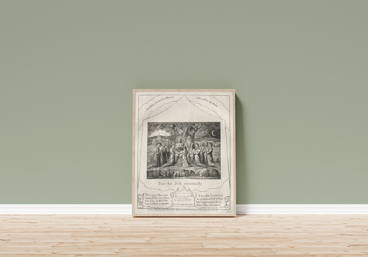 Framed art print of Thus Did Job Continually (Book of Job, Plate 1) by William Blake, in a light wood frame leaning on a sage green wall above a wooden floor