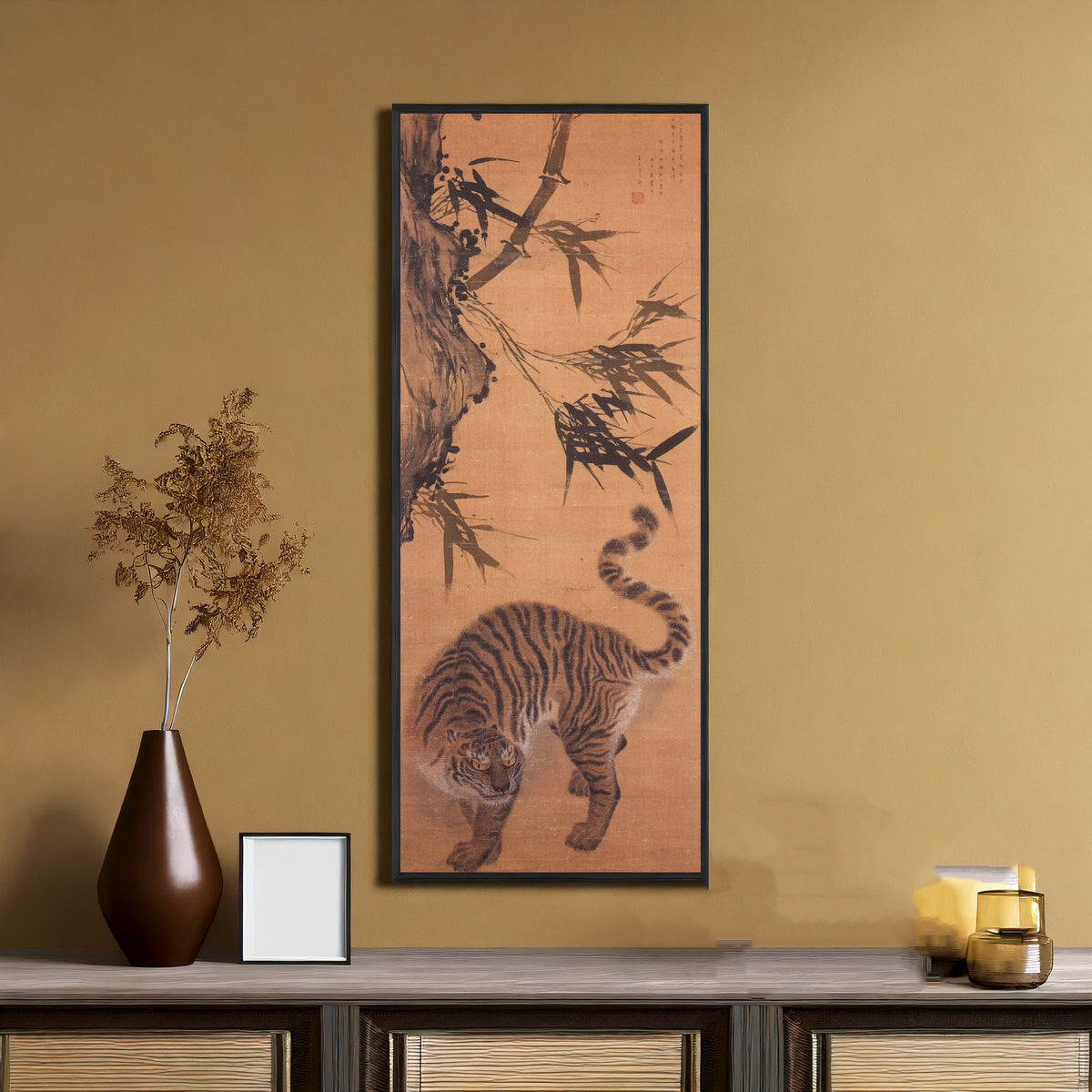 Framed art print of Tiger under Bamboo by Kim Hong-do (Danwon), on an ochre wall above a console table
