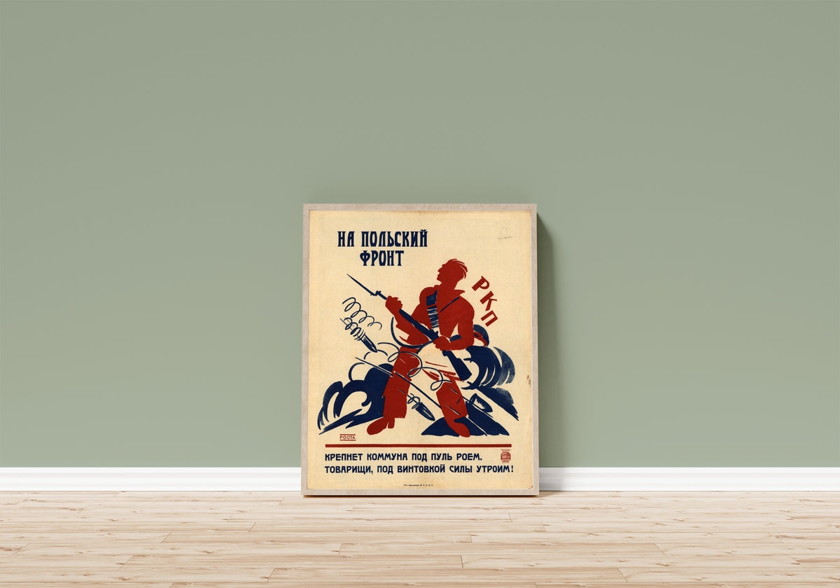 Framed art print of To the Polish front: the Commune grows strong… by Ivan Malyutin, in a light wood frame leaning on a sage green wall above a wooden floor