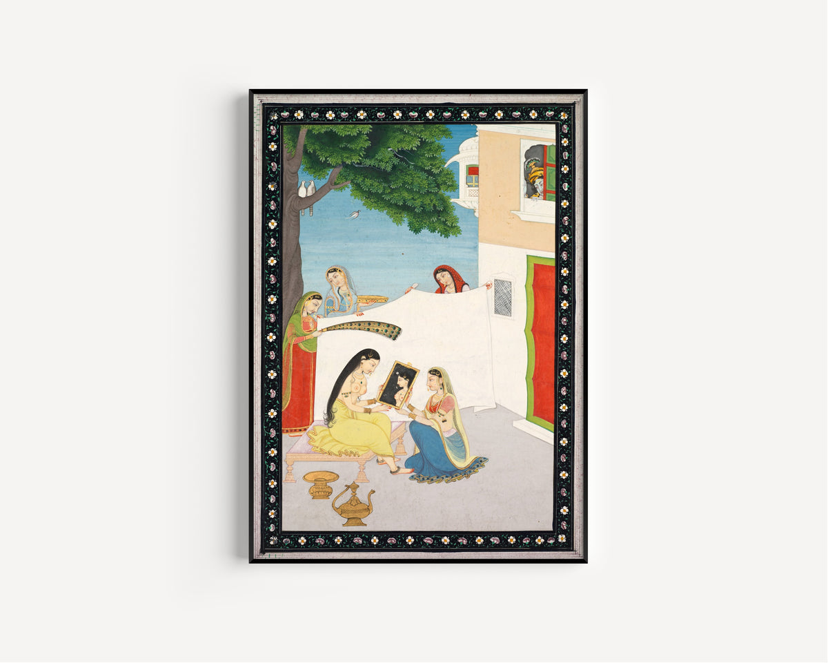 Framed art print of Toilette of Radha by Pahari school, in a slim black frame on a plain white wall