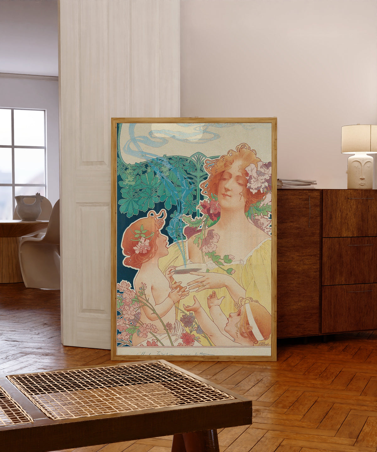 Framed art print of Tropon Chocolat-Cacao (before letters) by Henri Privat-Livemont, in a light wood frame leaning in a warm room with a parquet floor