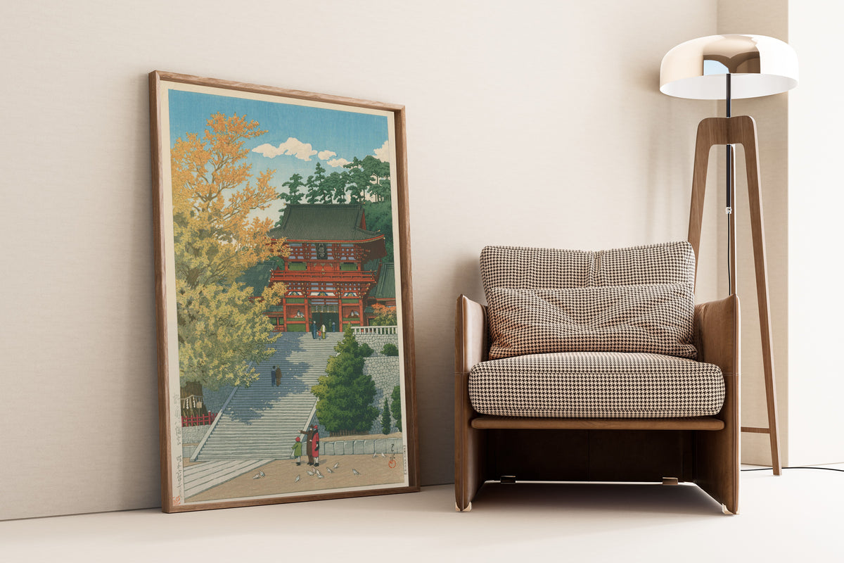 Framed art print of Tsurugaoka Hachimangu Shrine, Kamakura by Kawase Hasui, leaning against a wall beside an armchair and a floor lamp