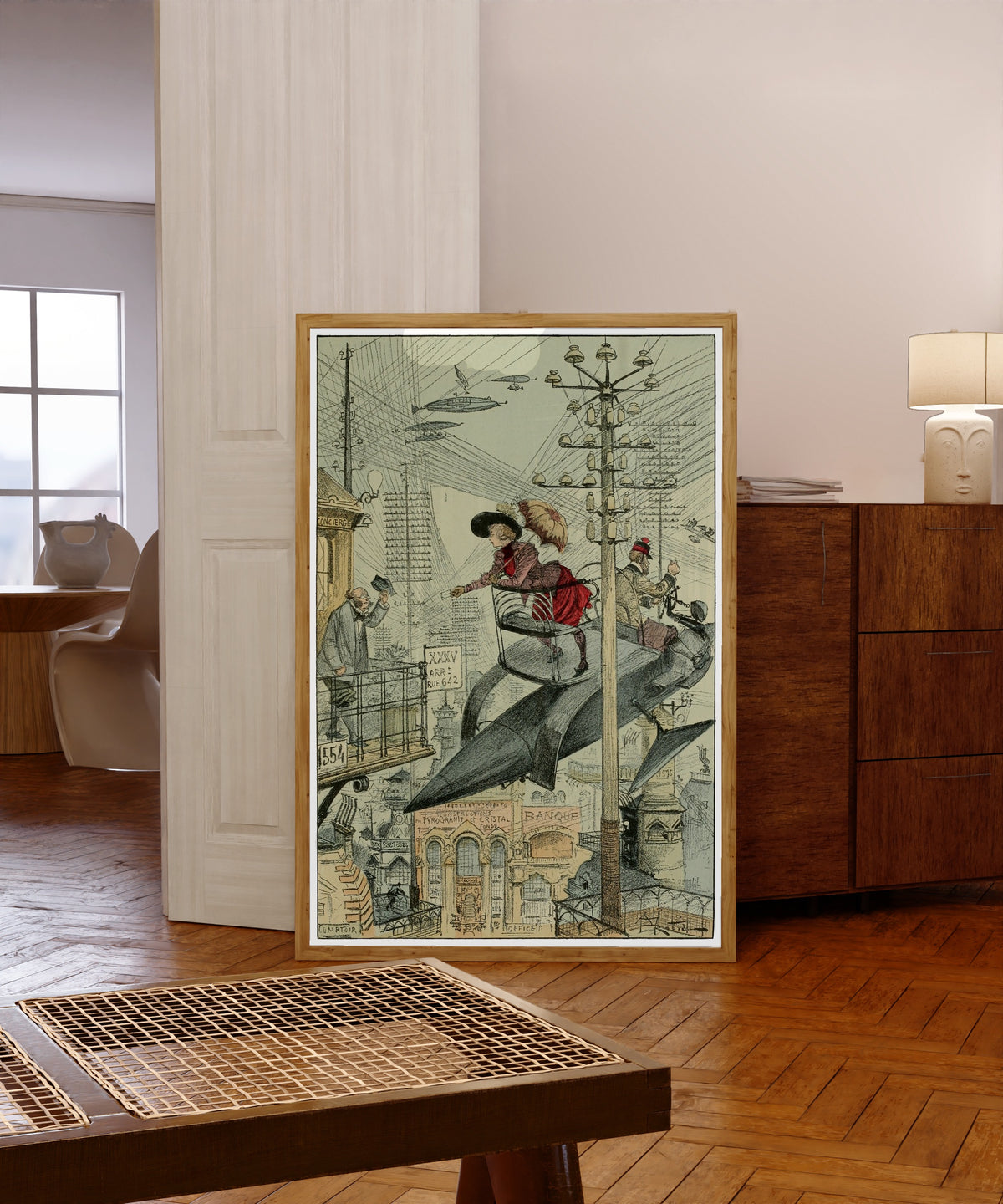 Framed art print of Un quartier embrouillé by Albert Robida, in a light wood frame leaning in a warm room with a parquet floor