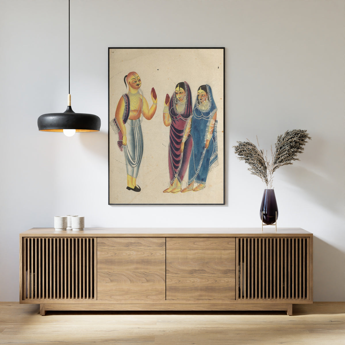 Framed art print of Vaishnava Devotee with Two Women by Kalighat painter, above a slatted wood sideboard