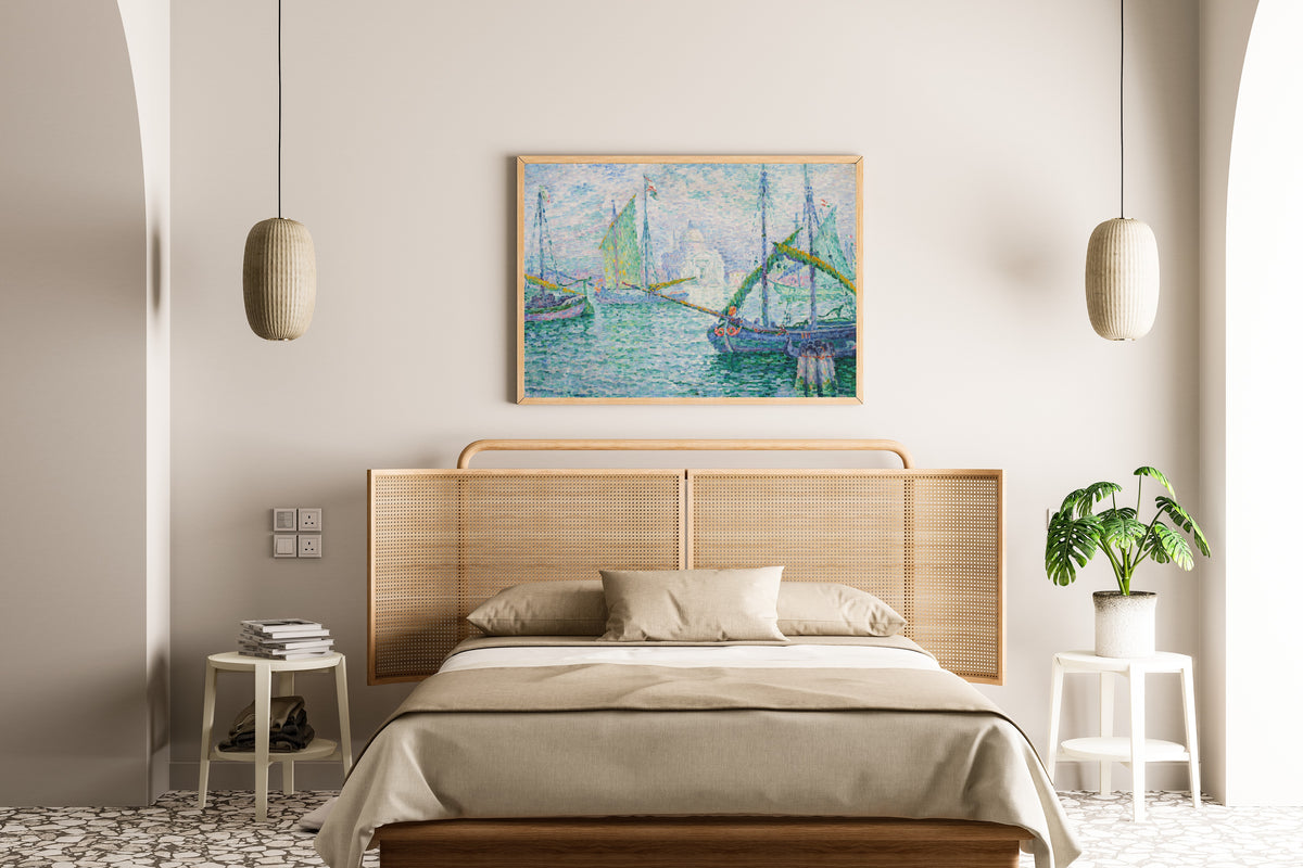 Framed art print of Venice, Il Redentore by Paul Signac, above a cane-headboard bed