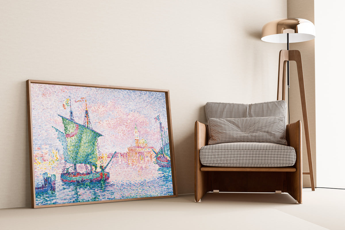 Framed art print of Venice, The Pink Cloud by Paul Signac, leaning against a wall beside an armchair and a floor lamp