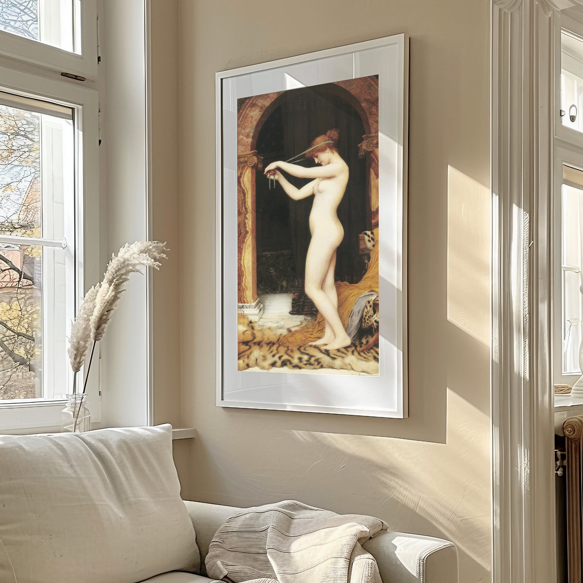 Framed art print of Venus Binding Her Hair by John William Godward, in a sunlit living room above a sofa