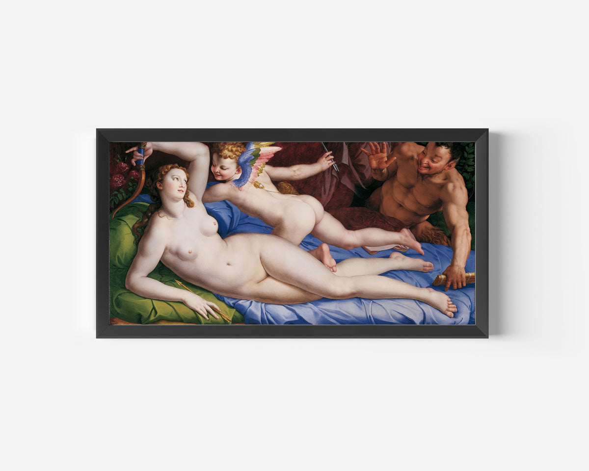 Framed art print of Venus, Cupid and Satyr by Bronzino, in a wide black frame on a plain white wall