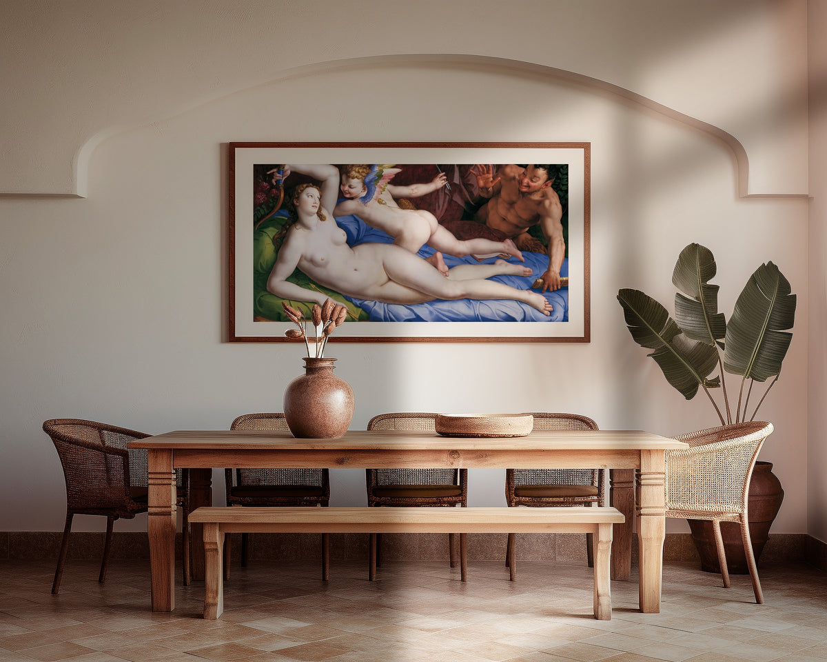 Framed art print of Venus, Cupid and Satyr by Bronzino, above a wooden dining table