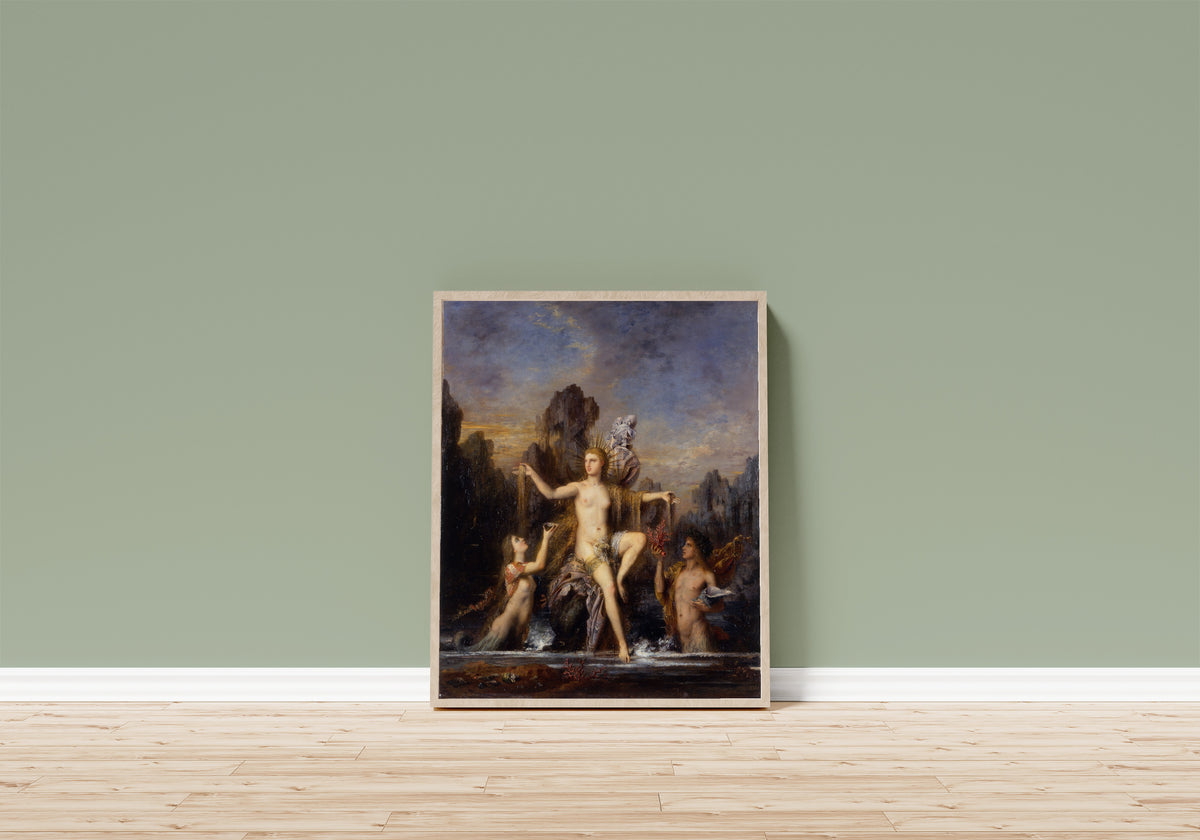 Framed art print of Venus Rising from the Sea by Gustave Moreau, in a light wood frame leaning on a sage green wall above a wooden floor
