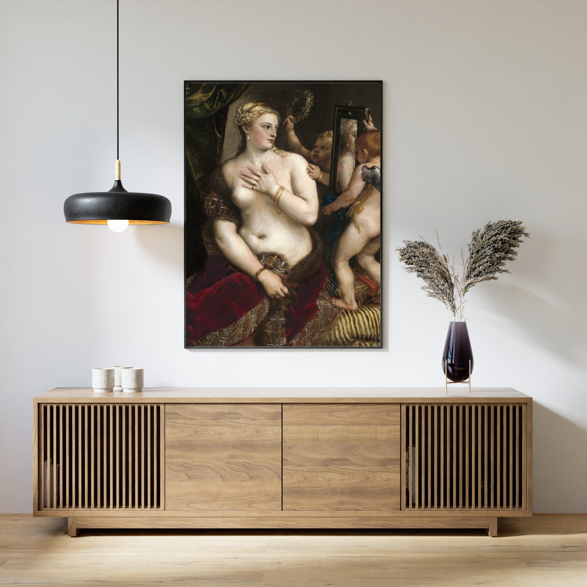 Framed art print of Venus with a Mirror by Titian, above a slatted wood sideboard