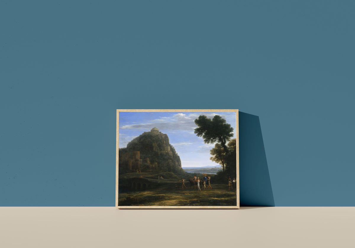 Framed art print of View of Delphi with a Procession by Claude Lorrain, in a light wood frame leaning on a blue wall