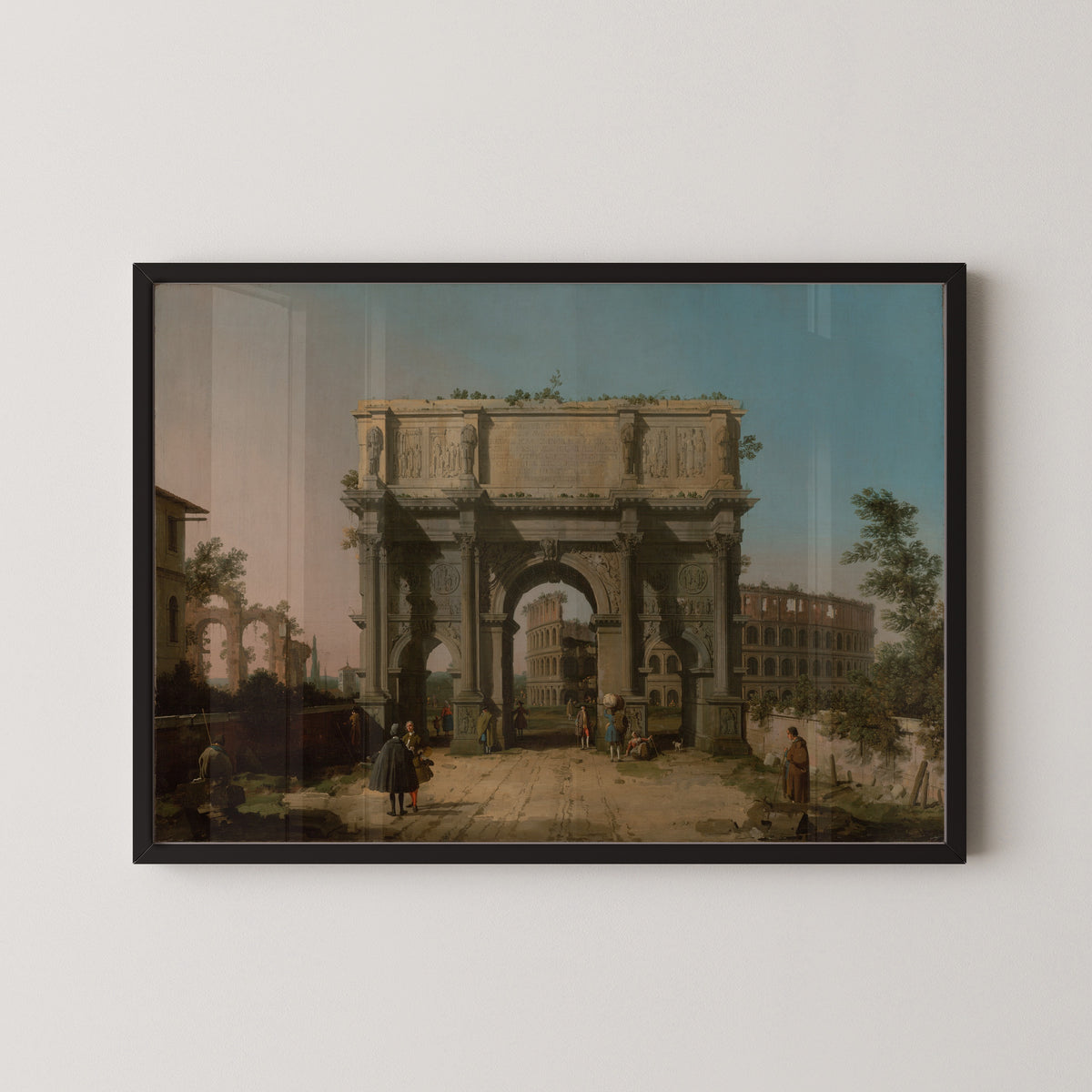 Framed art print of View of the Arch of Constantine with the Colosseum by Canaletto, in a black frame on a pale wall
